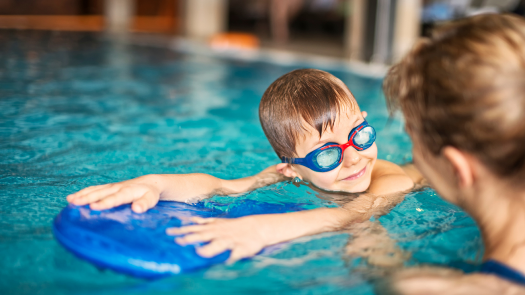 Young boy getting swim lessons in pool