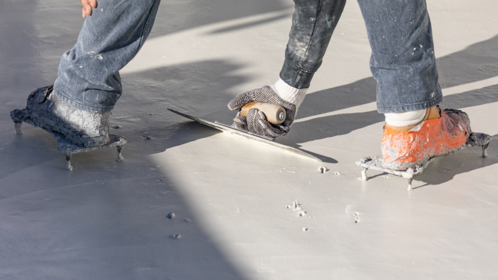 Man smoothing out white pool plaster